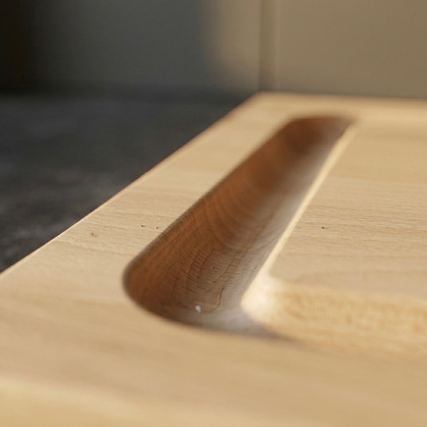 Detailaufnahme eines Schneidebretts aus Buche Massivholz mit Saftrille und feiner Holzstruktur