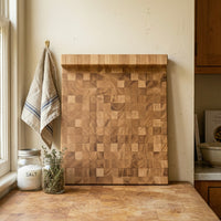 Stirnholz Schneidebrett aus Eiche mit Anschlagkante an einer Küchenwand, neben Gewürzglas und Geschirrtuch